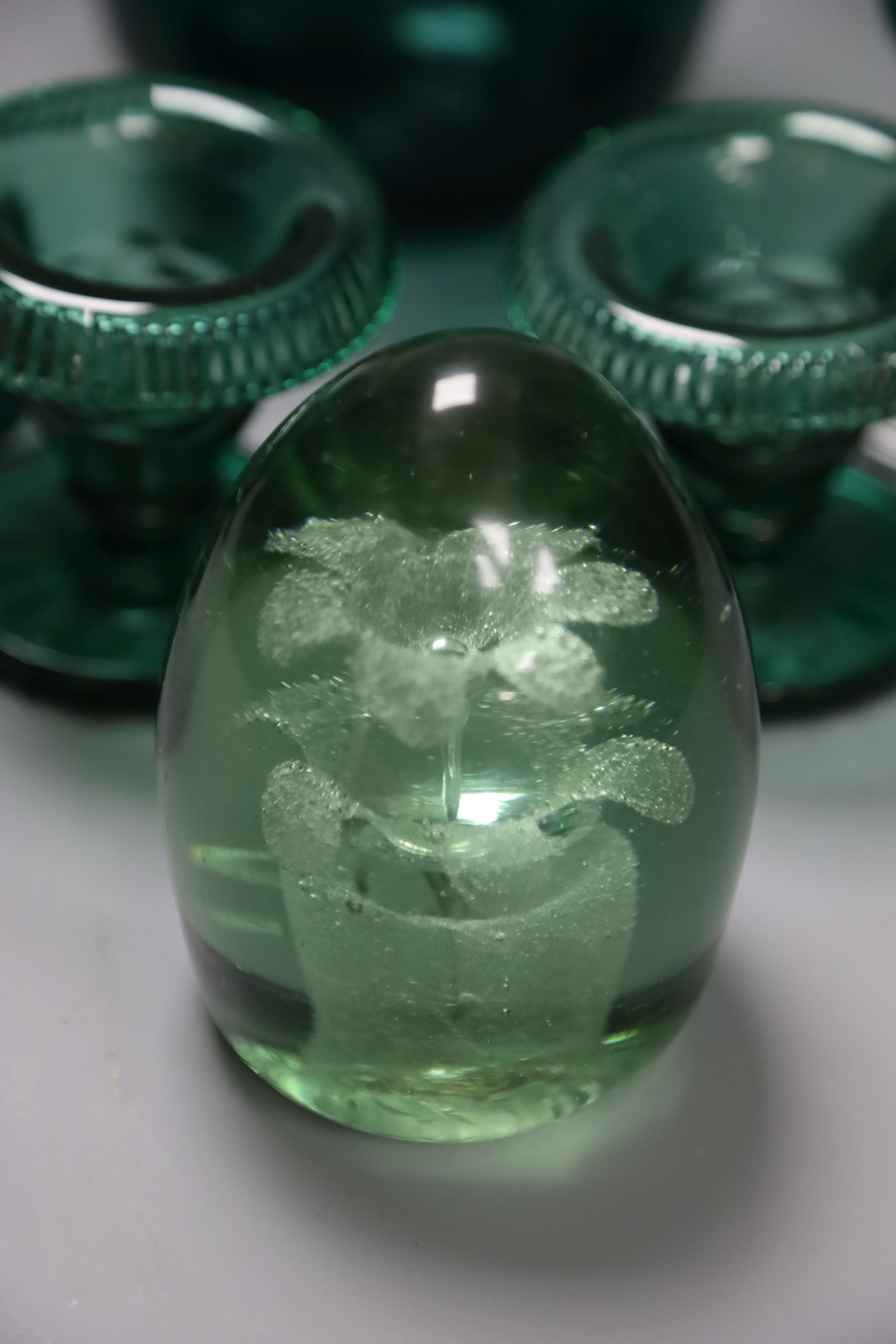 A group of 19th century green glass and a Victorian dump paperweight